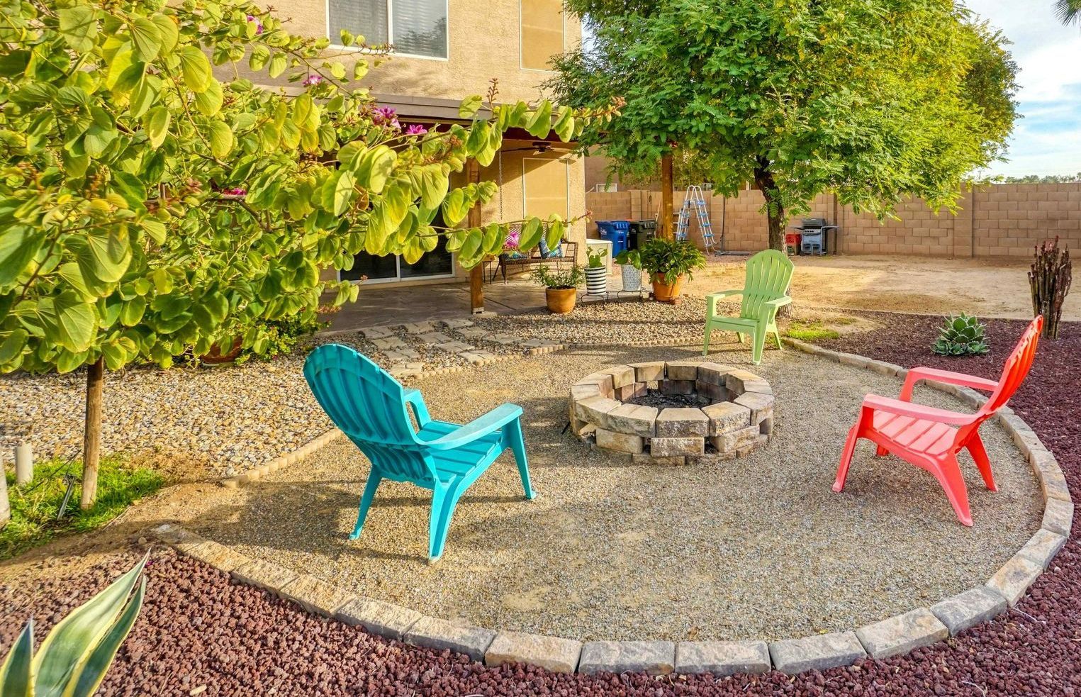 Stone fire pit for outside living in a landscaped backyard in Carson City Nevada