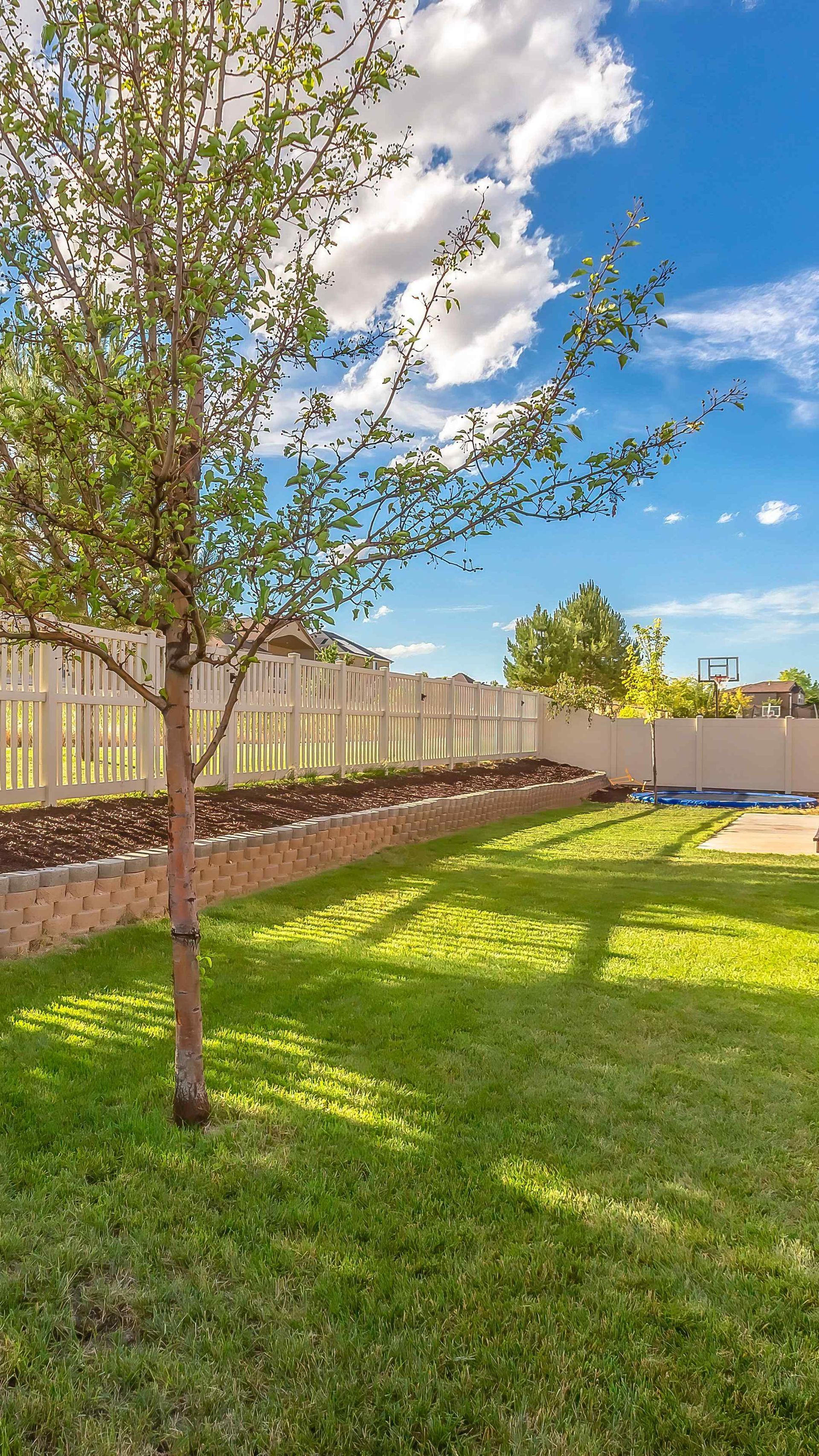 Backyard fence installation above a retaining wall garden bed in Carson City Nevada