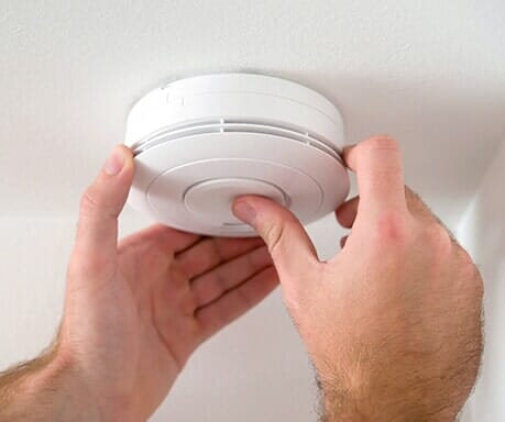 Interior Security Systems — Man Installing Smoke Detector in Campbell, CA