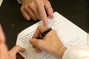 Signing a Document — Real Estate Attorney in Melrose, MA