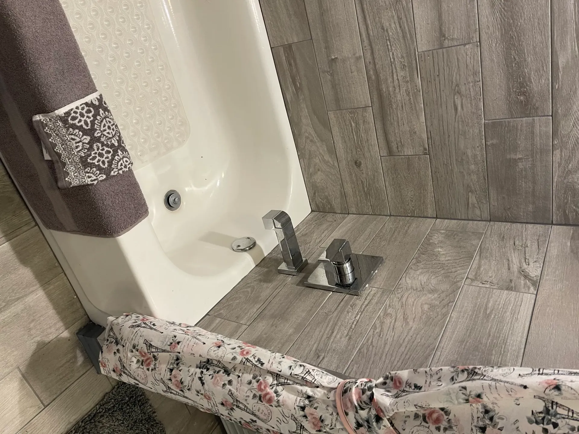A bathroom with a bathtub and a shower curtain.