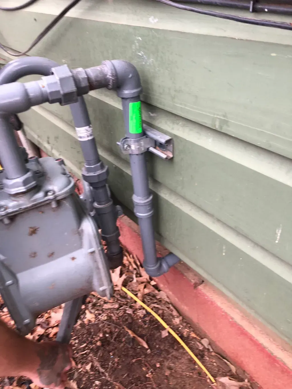 A close up of a pipe on the side of a building.