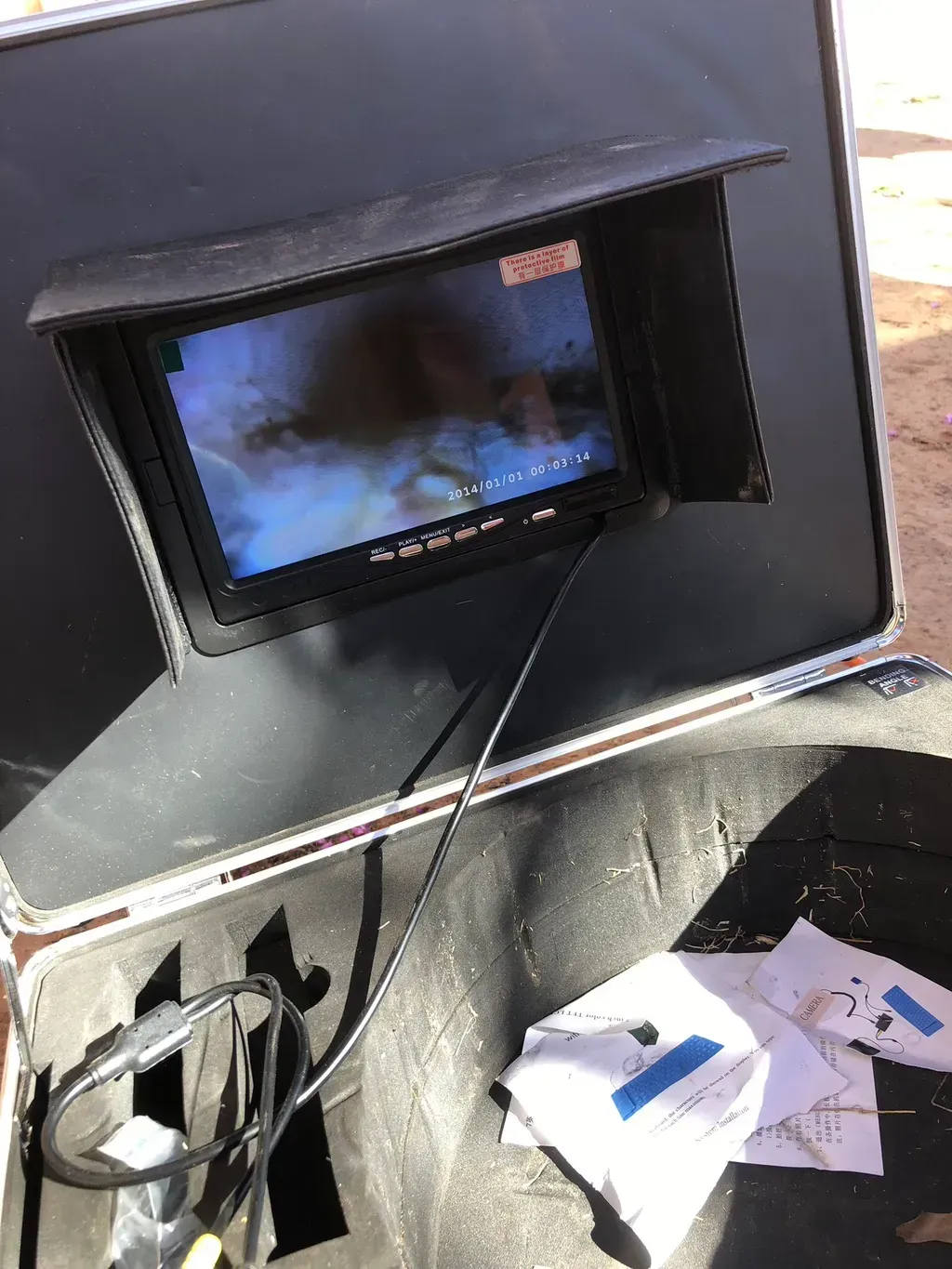 A small monitor is sitting on top of a box.