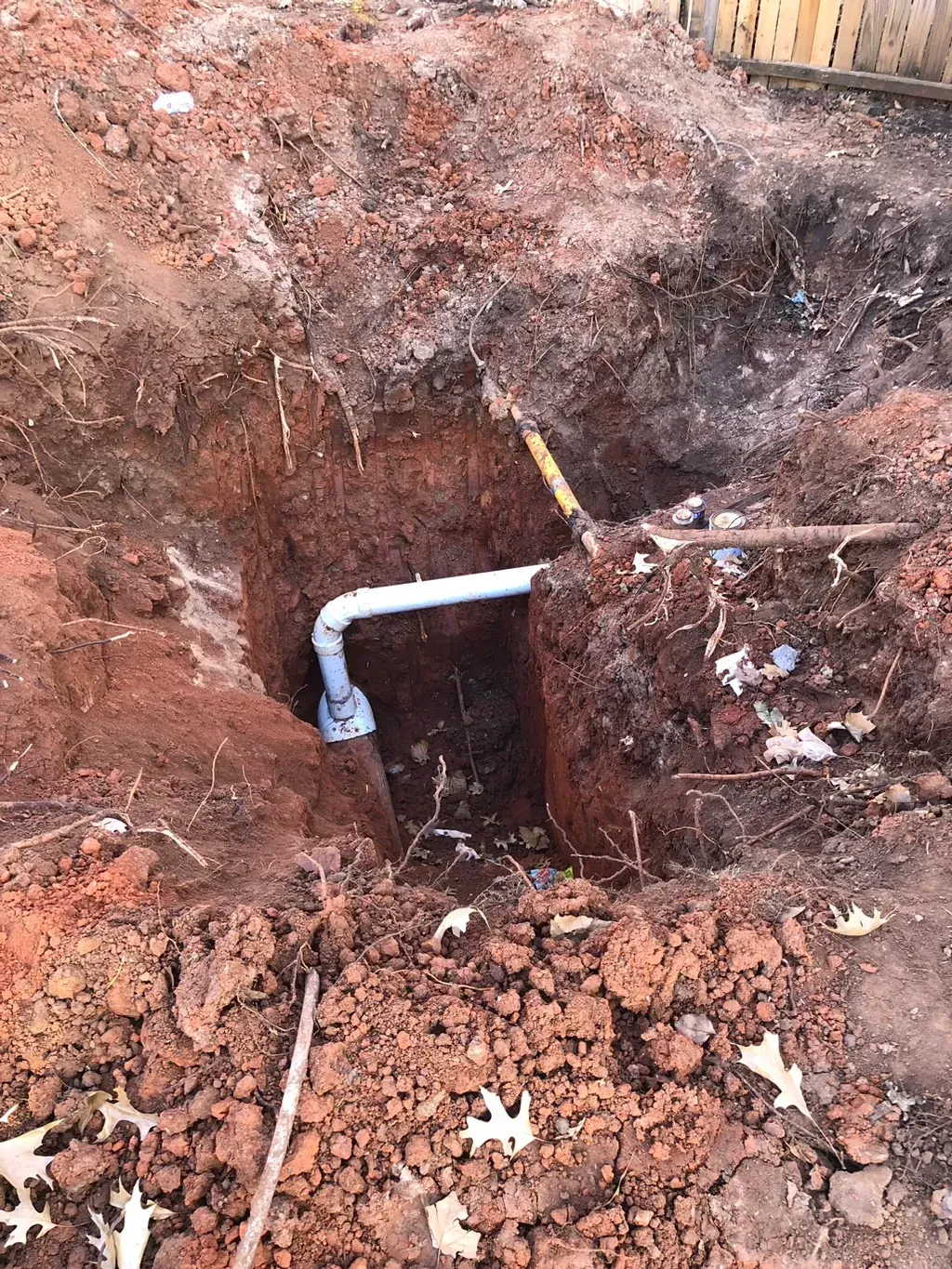 A pipe is being installed in a hole in the ground.