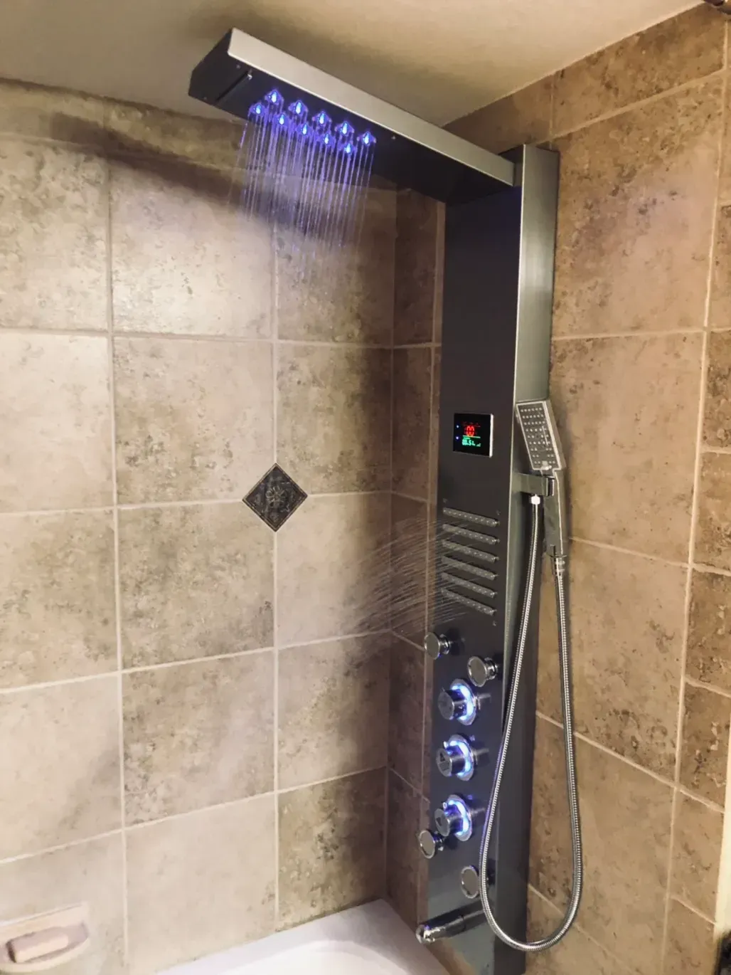 A bathroom with a shower head and a bathtub.