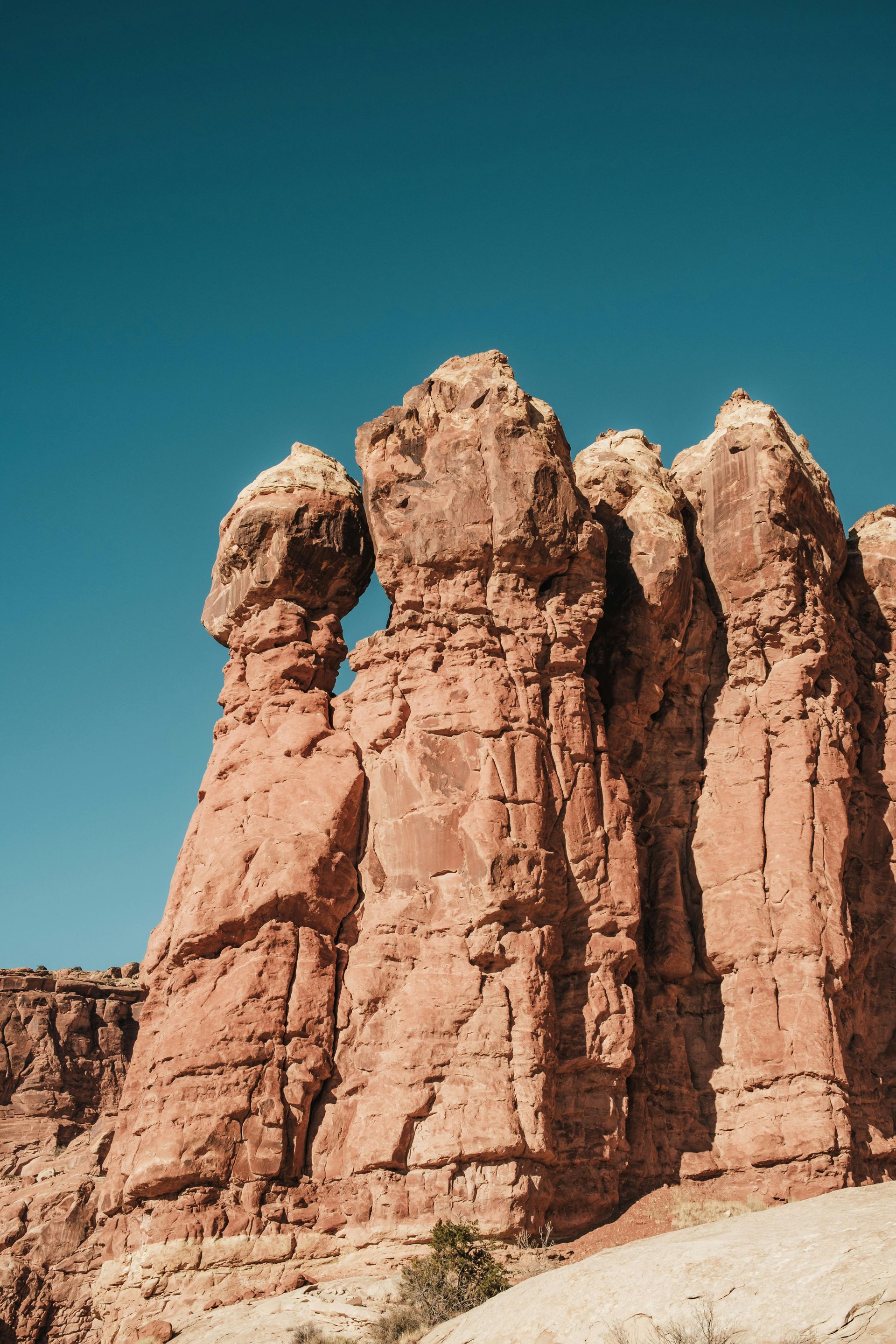 Red rock formations against a clear blue sky.