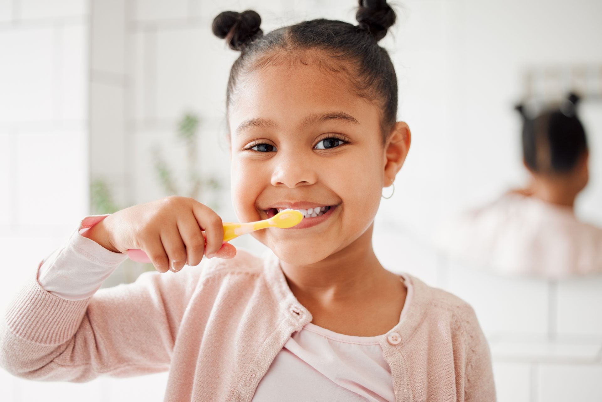 A girl is brushing her teeth at home: dental health and wellness.