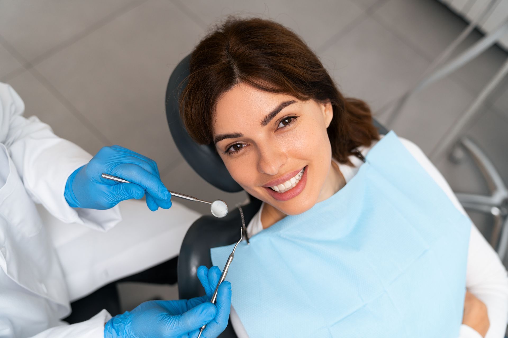 A dentist is performing a general check-up on a patient's teeth.
