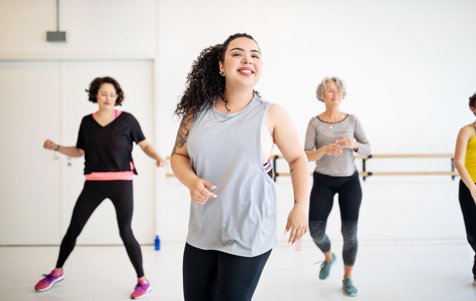 A group of women are dancing together in a dance studio.