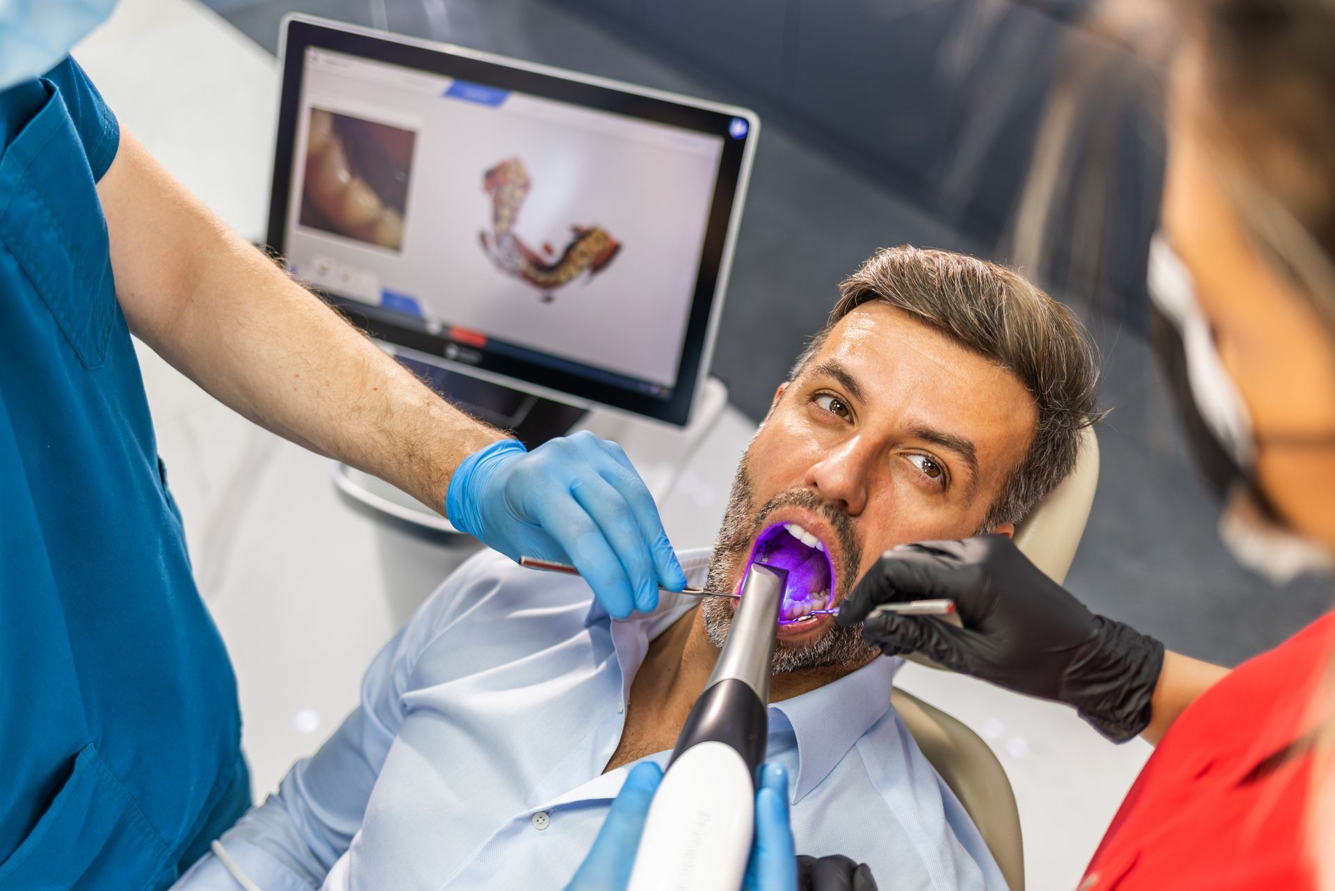 A dental office with a dental chair and chairs.
