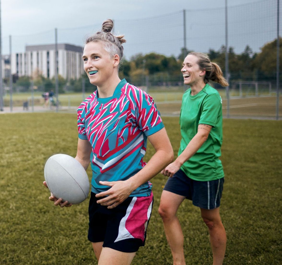 A woman is holding a clear retainer in her hands in a dental office.
