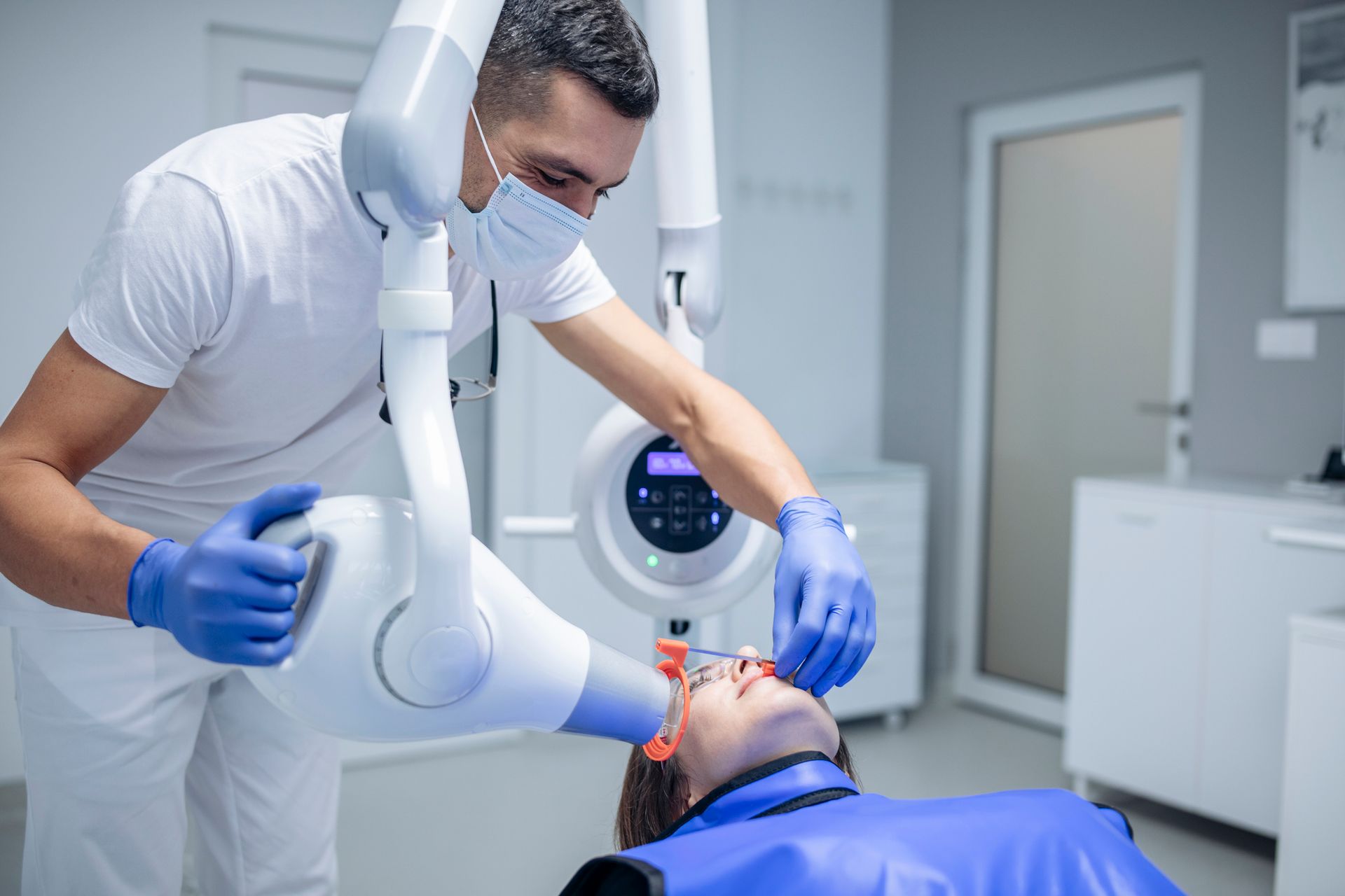 A dentist is showing a patient an x-ray of his teeth.