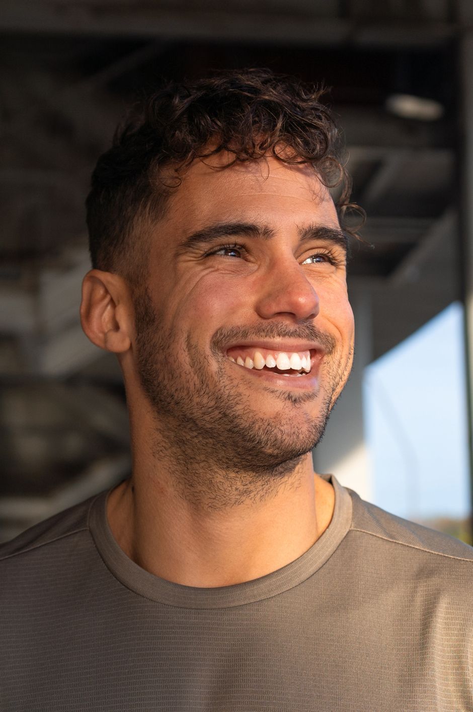 A close up of a man with a beard smiling.