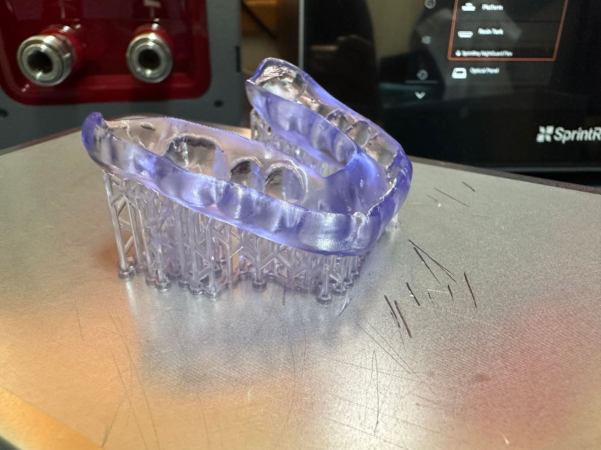 A dental model is being scanned by a machine.