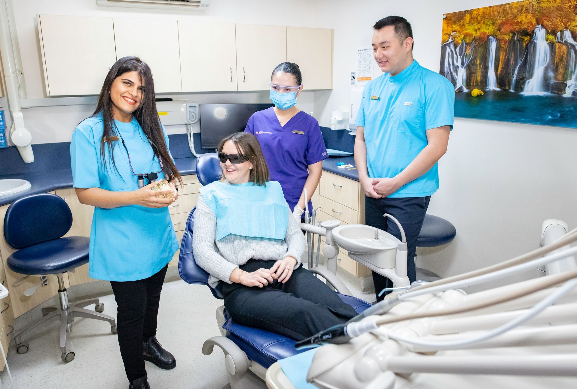 A blue and white dental chair in a dental office.