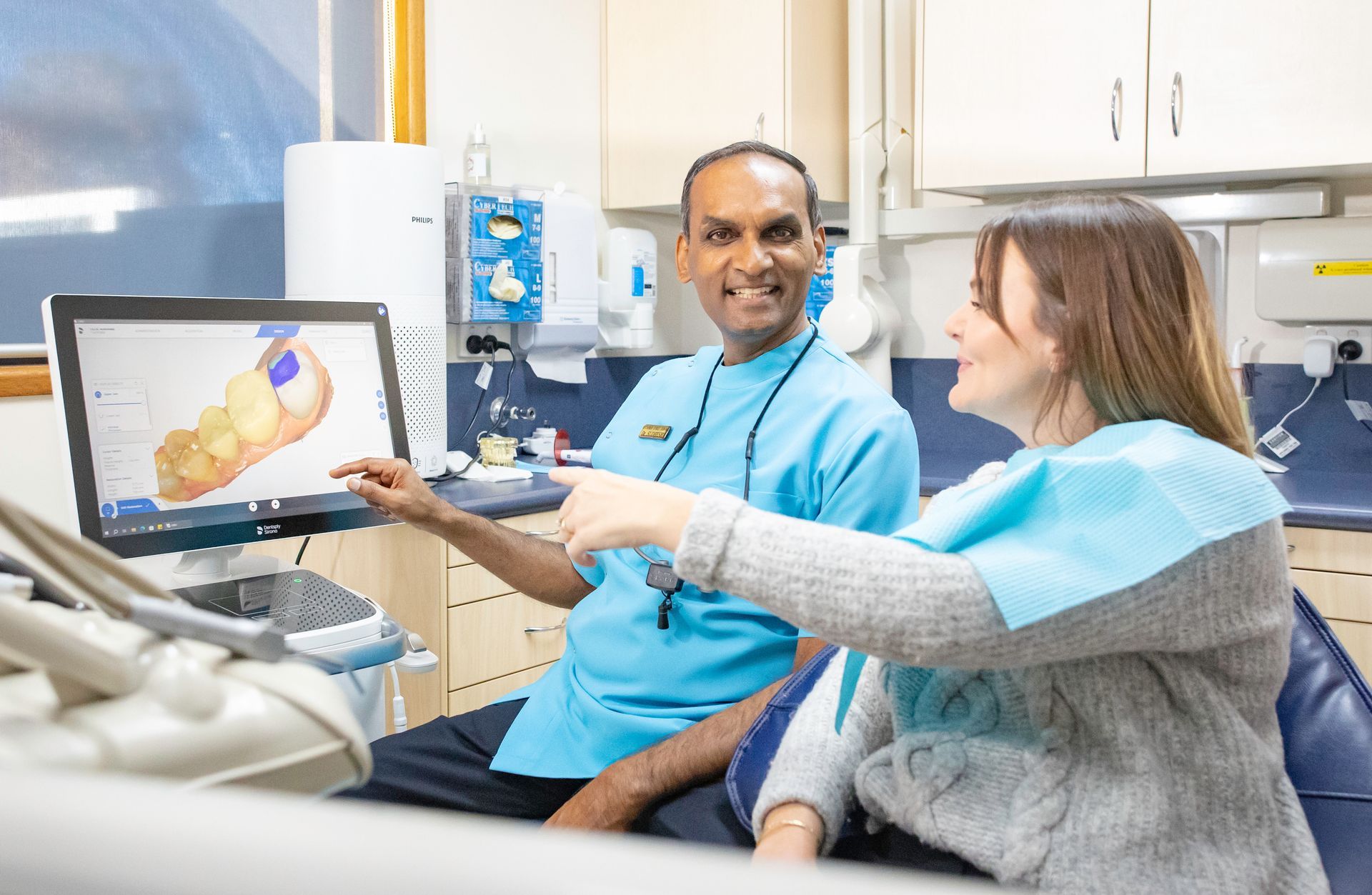 A man and a woman are giving each other a high five in a park.