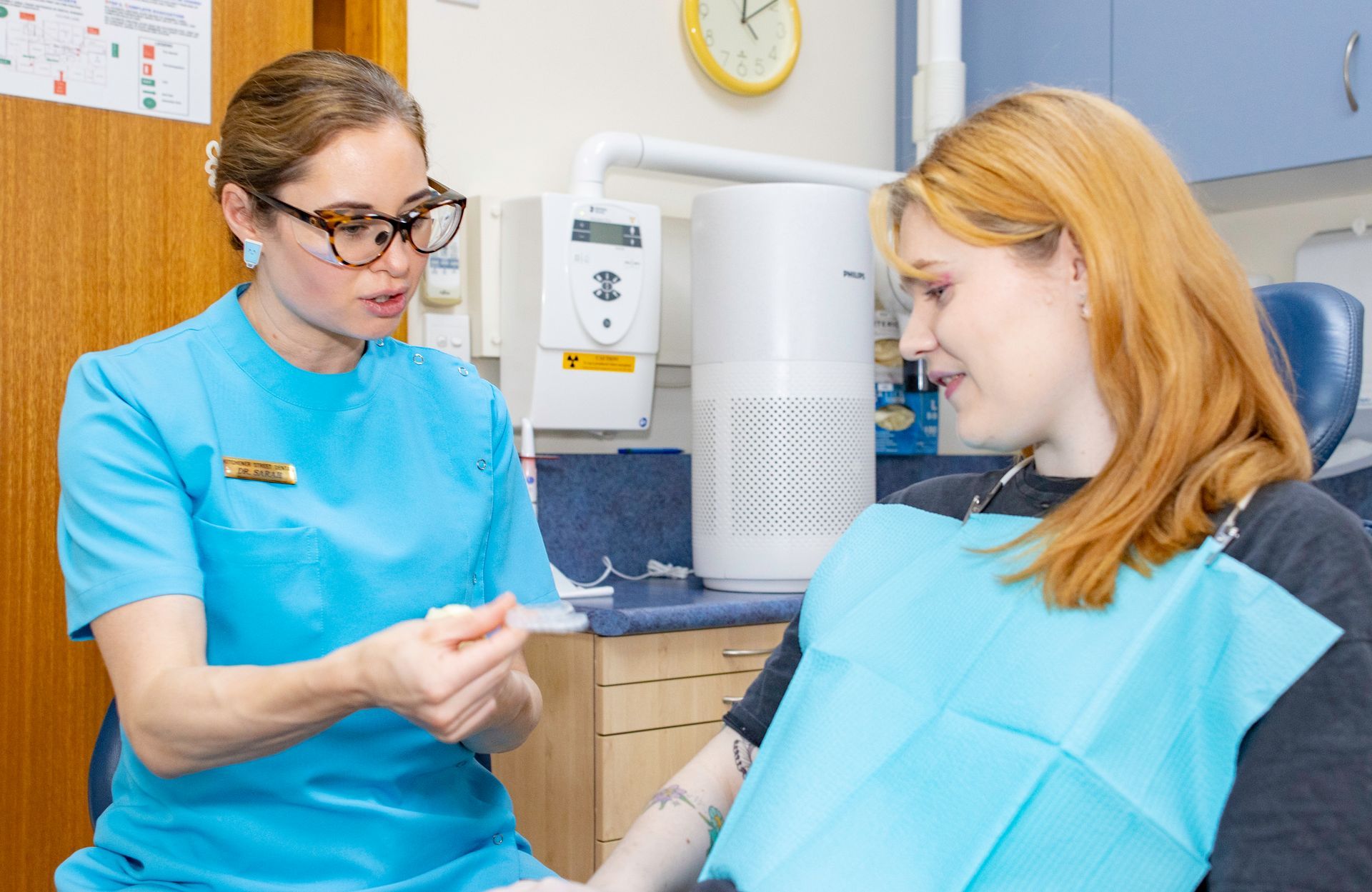 A close up of a model of a tooth being scanned by a machine.