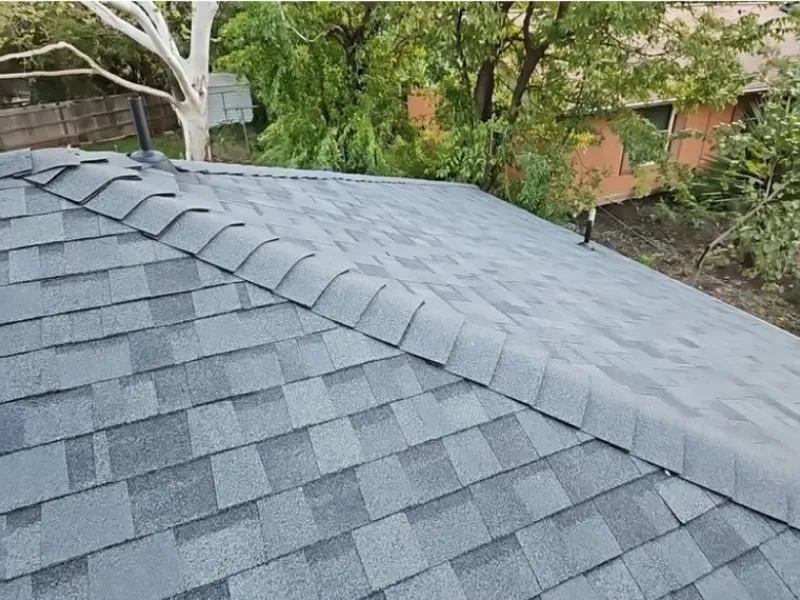 Gray asphalt shingle roof on a house, angled view.