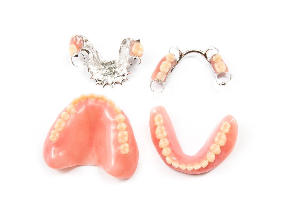 There Are Three Different Types of Dentures on a White Background — Dental Prosthetics By Richard & Cindy In Oxenford, QLD