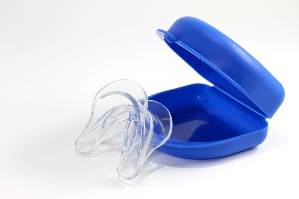 A Blue Case With a Clear Mouth Guard in It — Dental Prosthetics By Richard & Cindy In Oxenford, QLD