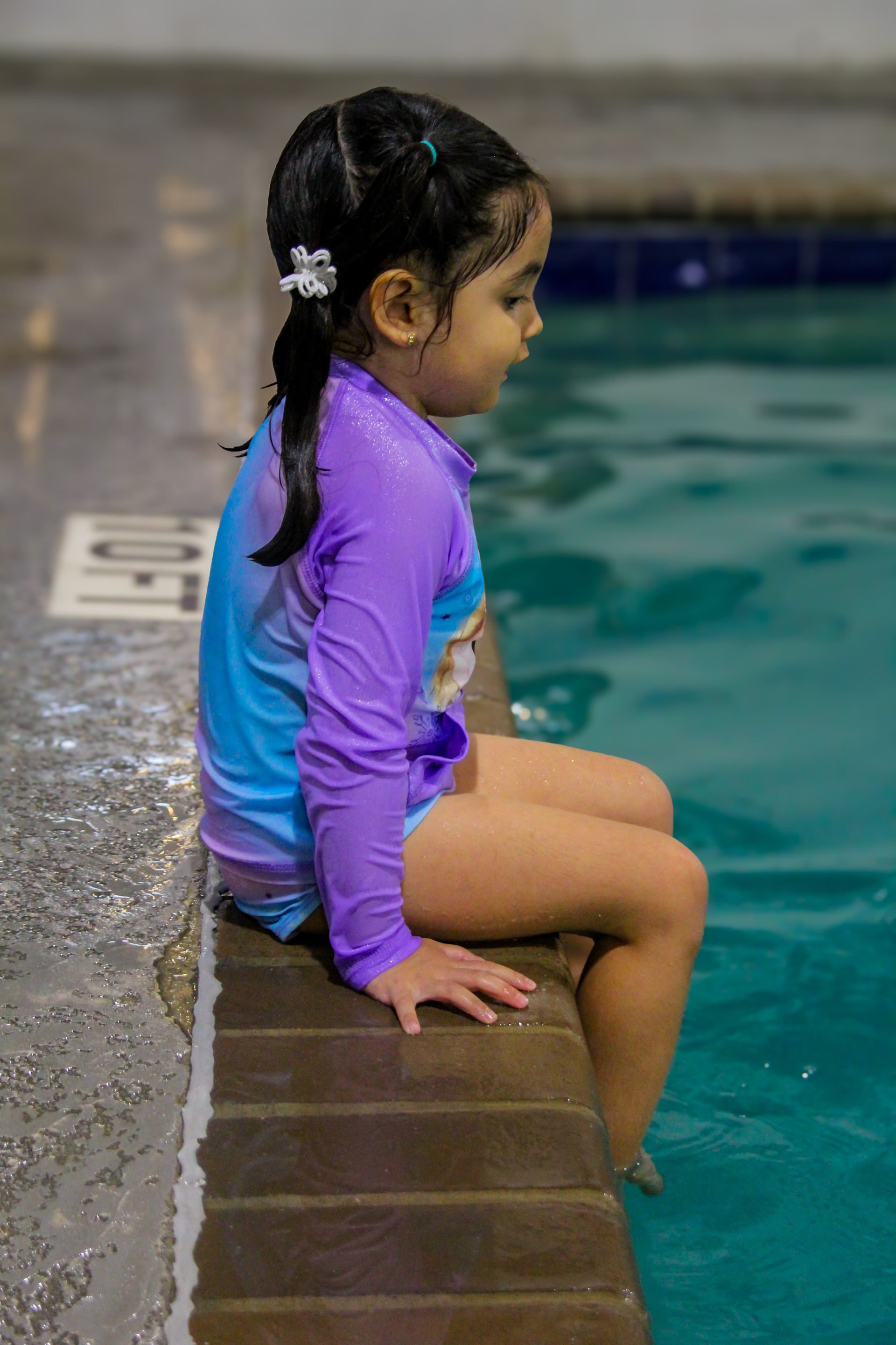 Swimming Lessons two young children are swimming in a swimming pool.