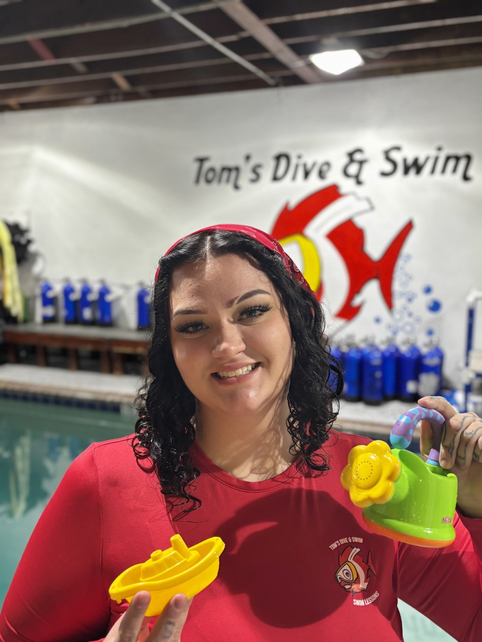 Swim Instructor Holding Dive Toys
