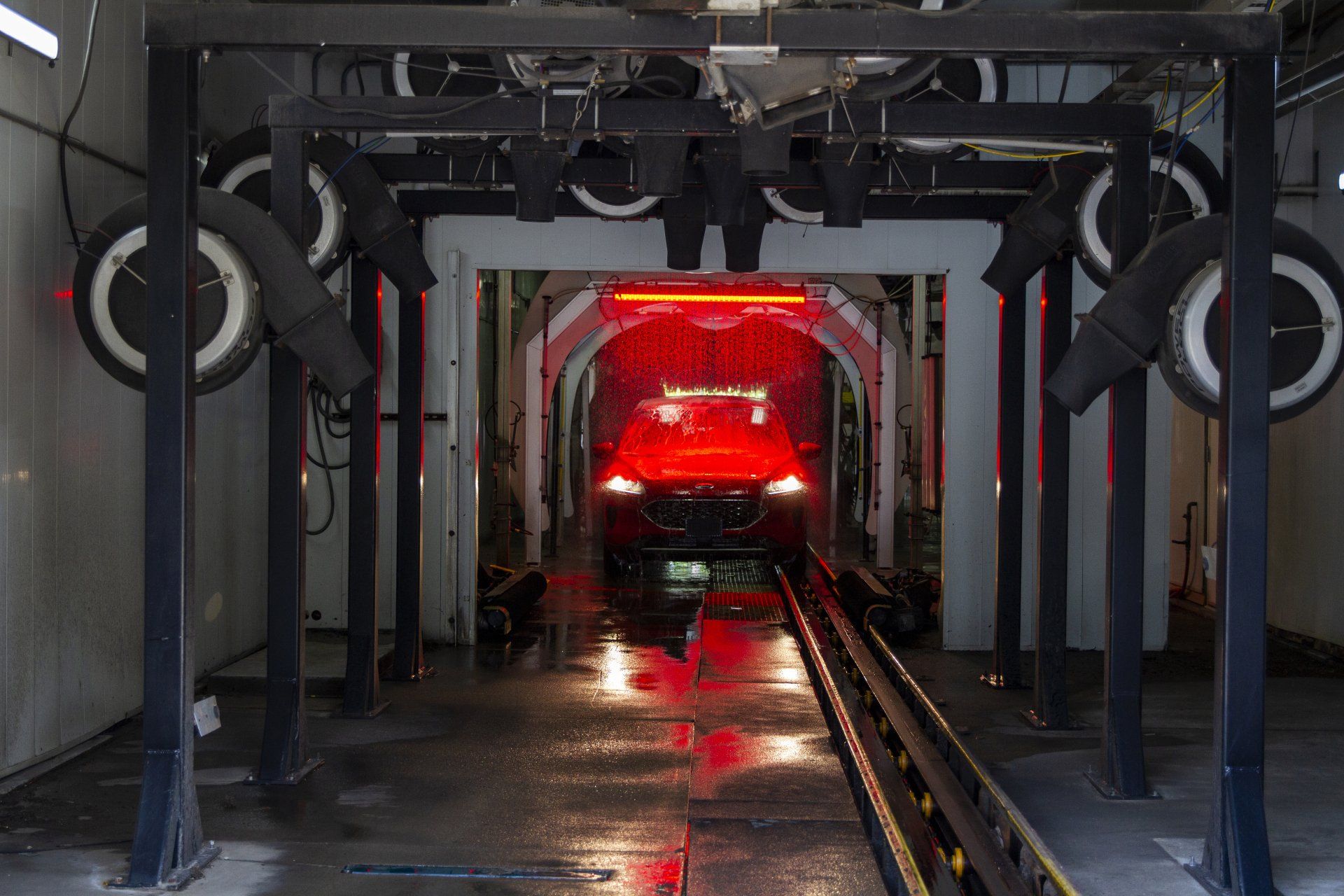 red car going through automated wash