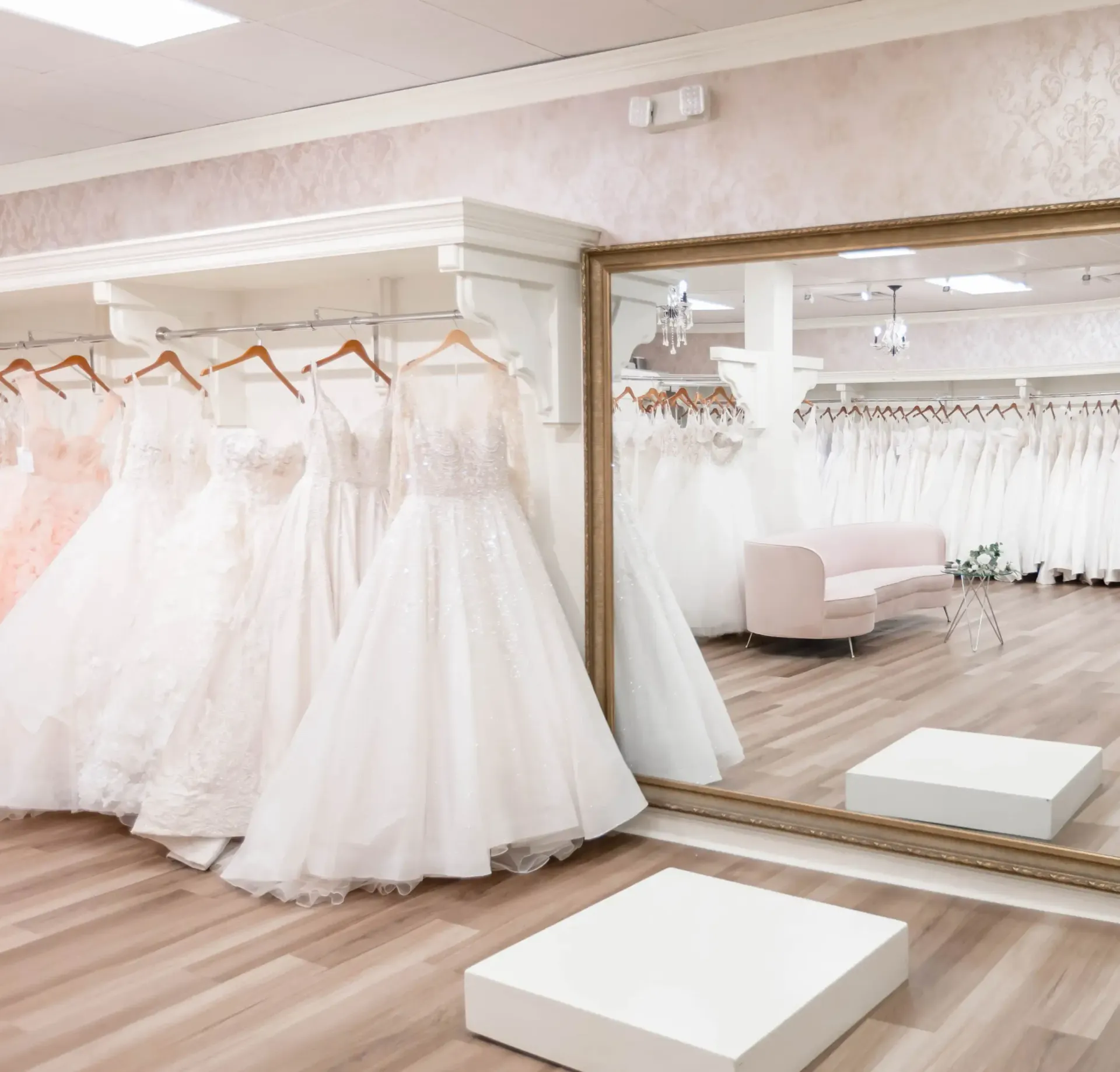 Exterior of a bridal shop called Blush, with wedding dresses in the windows and a sign above.