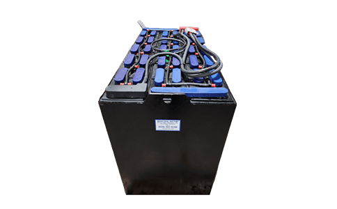 A black battery with blue cells is sitting on a white surface.