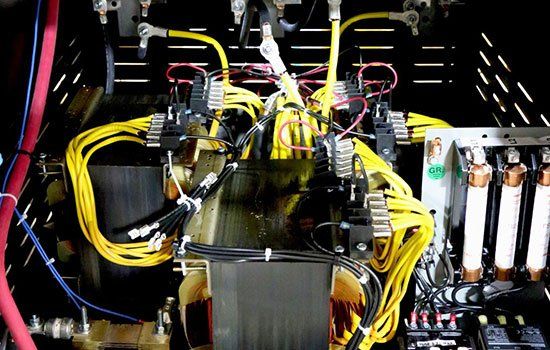 A close up of a transformer with a lot of wires coming out of it.