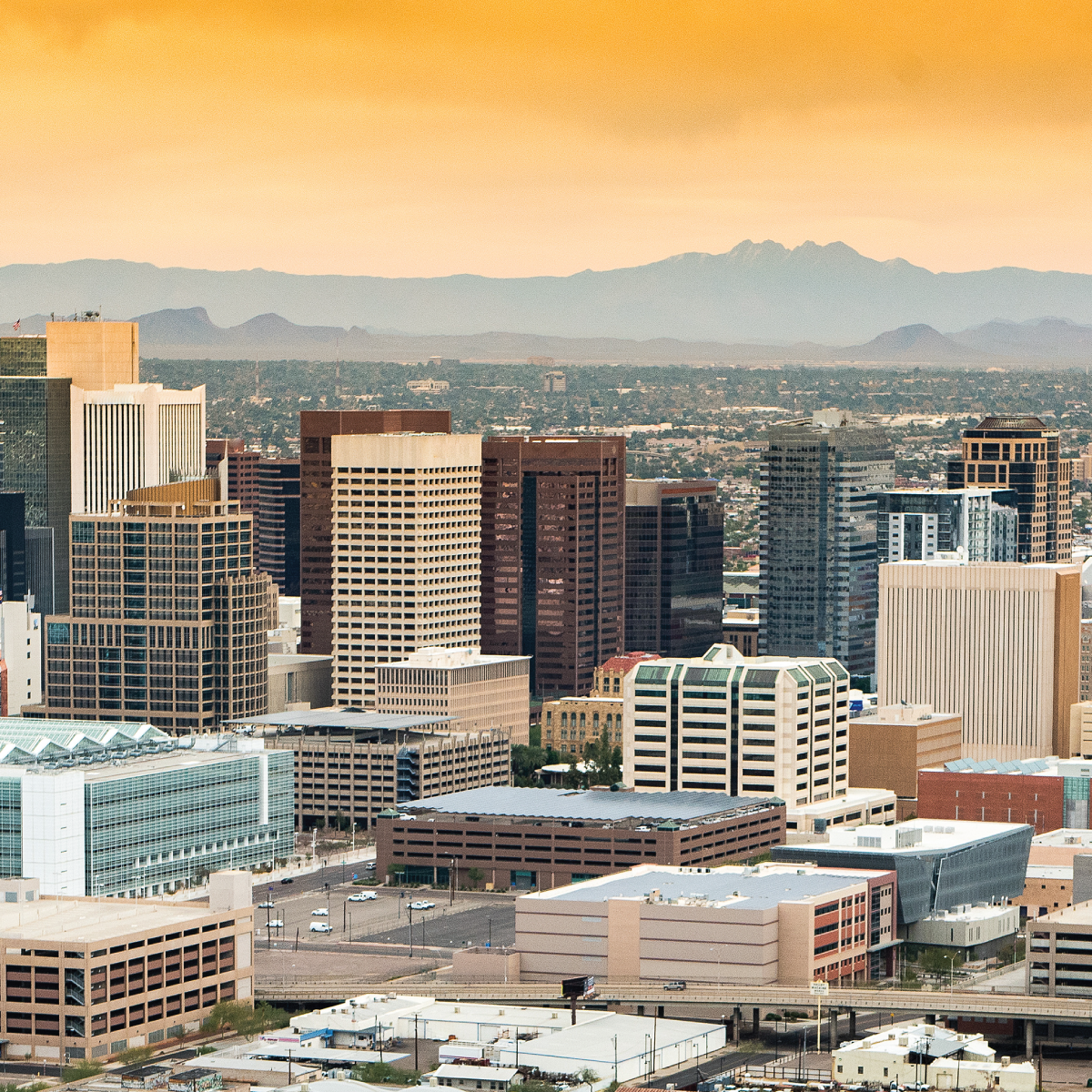 An aerial view of a city with mountains in the background