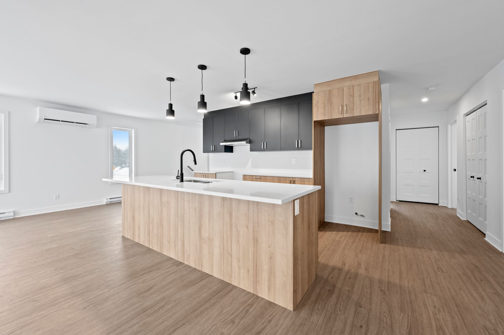 Une cuisine vide avec un grand îlot au milieu de la pièce.