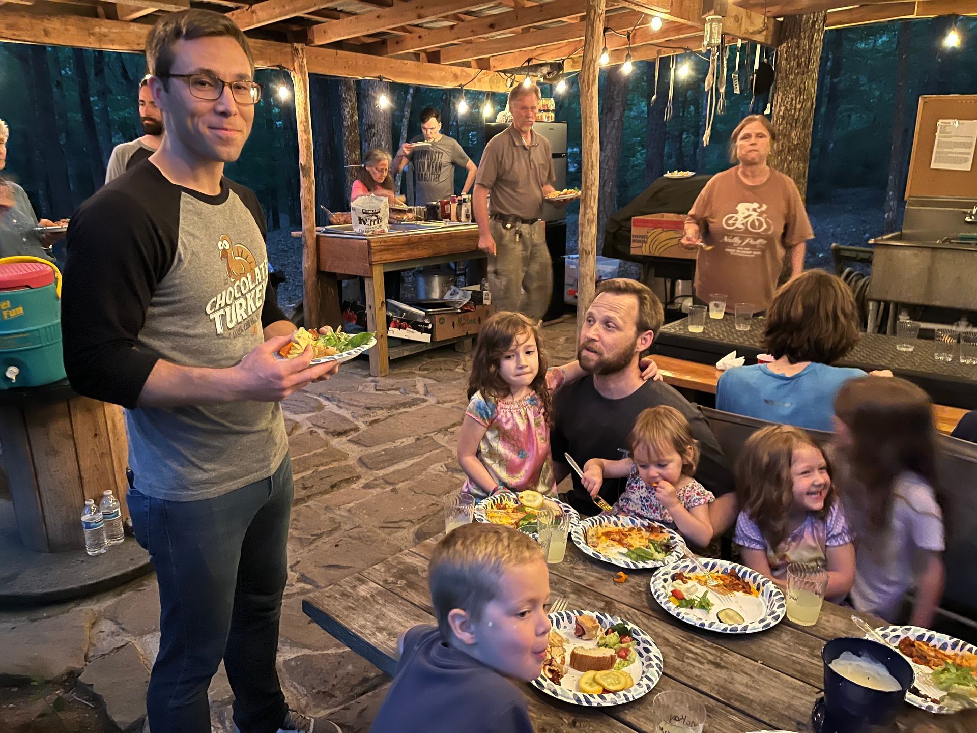 A group of people are sitting at a table eating food.