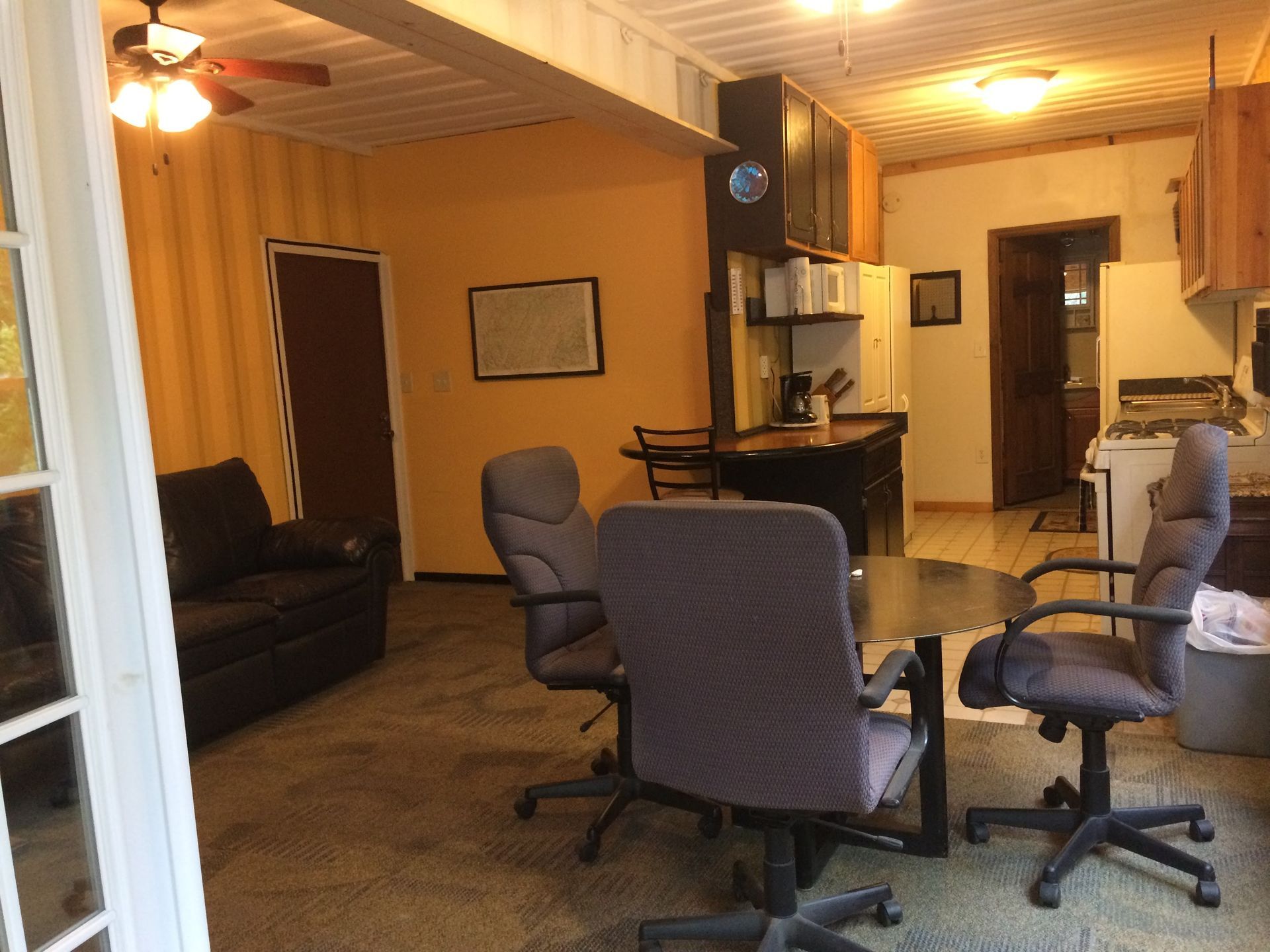 A living room with a table and chairs and a couch