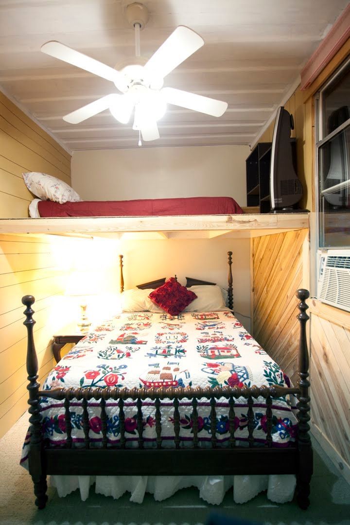 A bedroom with a bunk bed and a ceiling fan