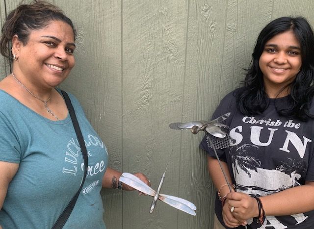 Two women standing next to each other one wearing a shirt that says sun