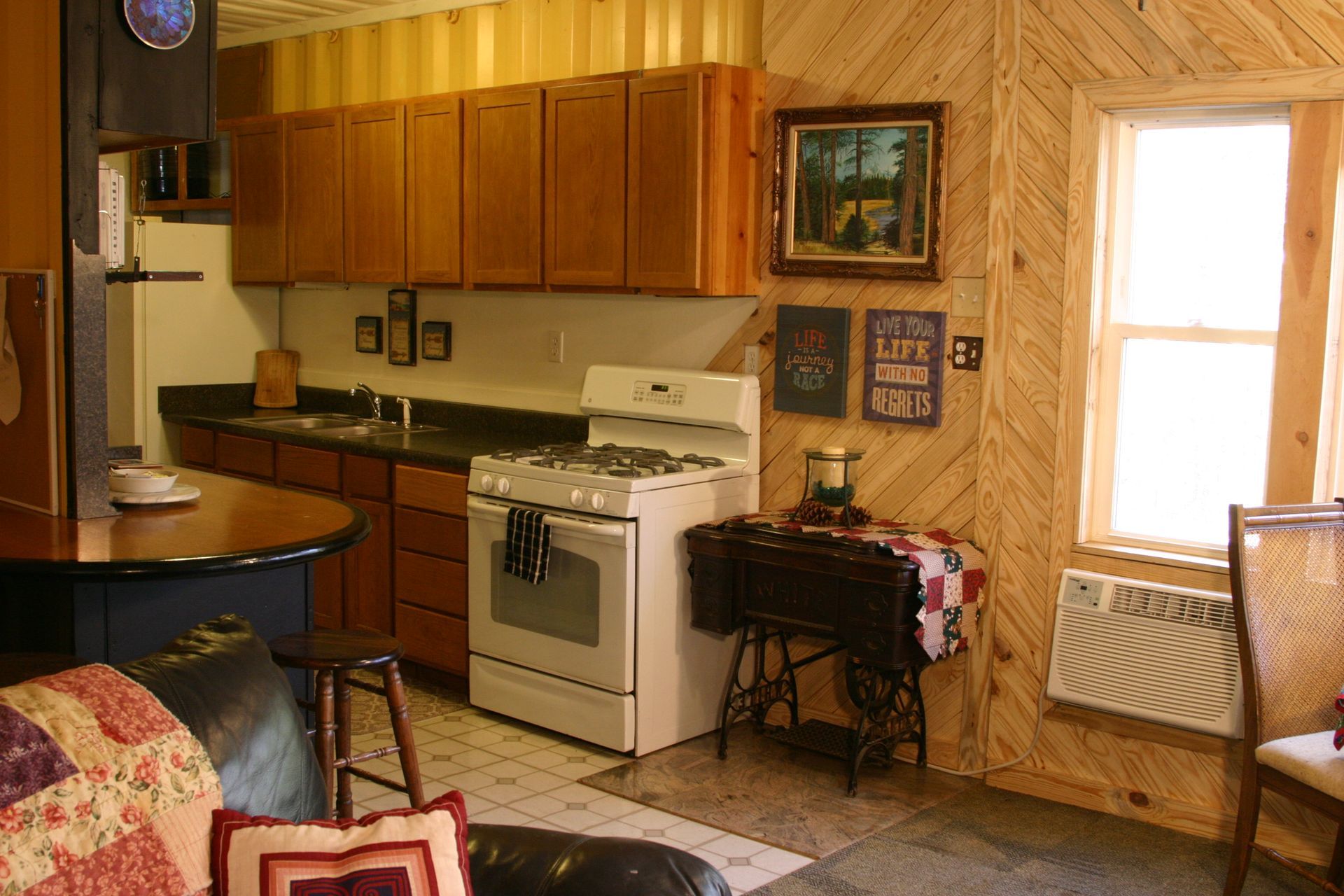 A kitchen with a sign that says life on the wall