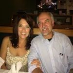 A man and a woman are sitting at a table in a restaurant.