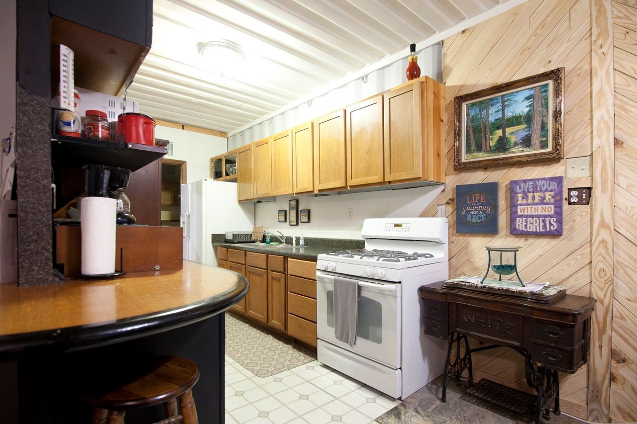 A kitchen with a stove and a sign that says let your life be wild