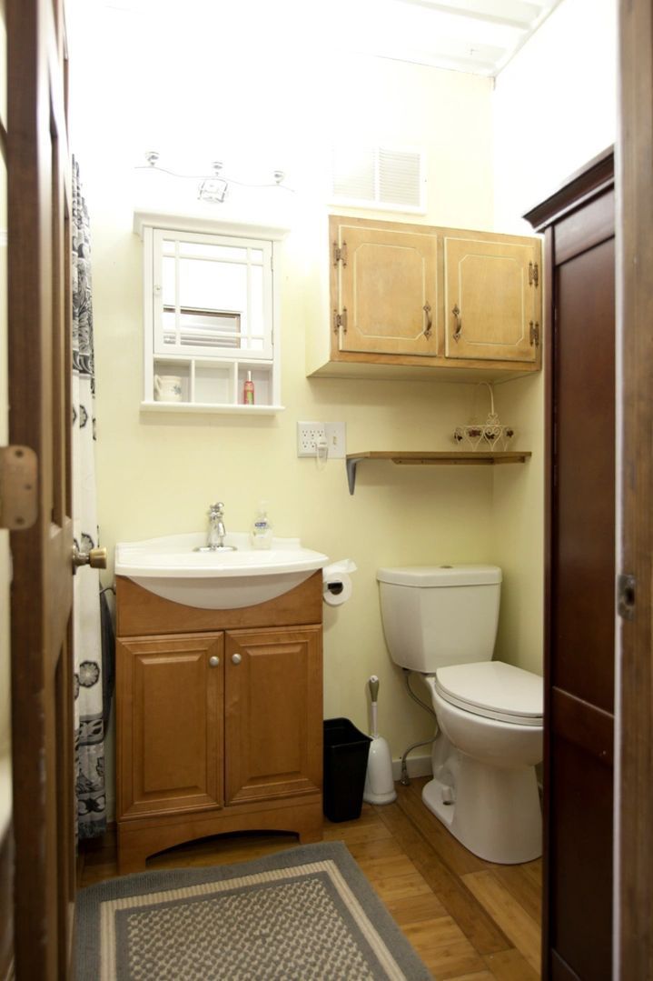 A bathroom with a sink , toilet and cabinets