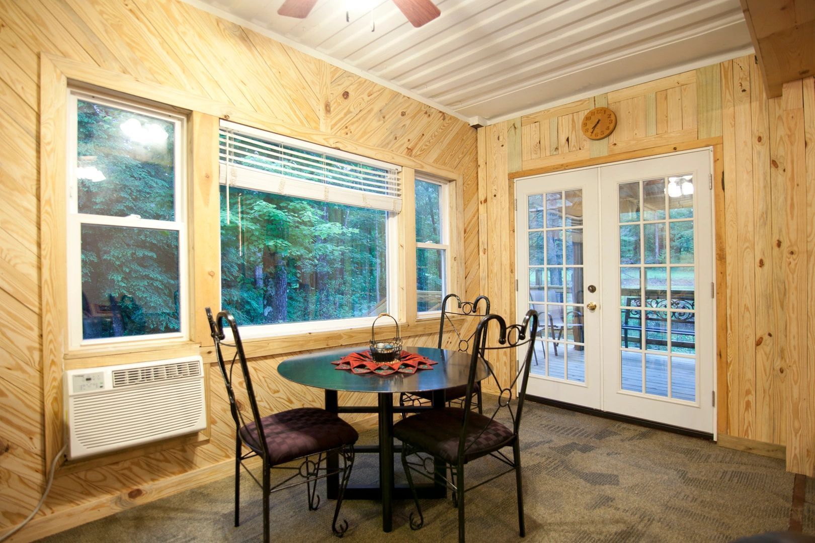 A dining room with a table and chairs and a ceiling fan