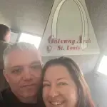 A man and a woman are posing for a picture on a bus.