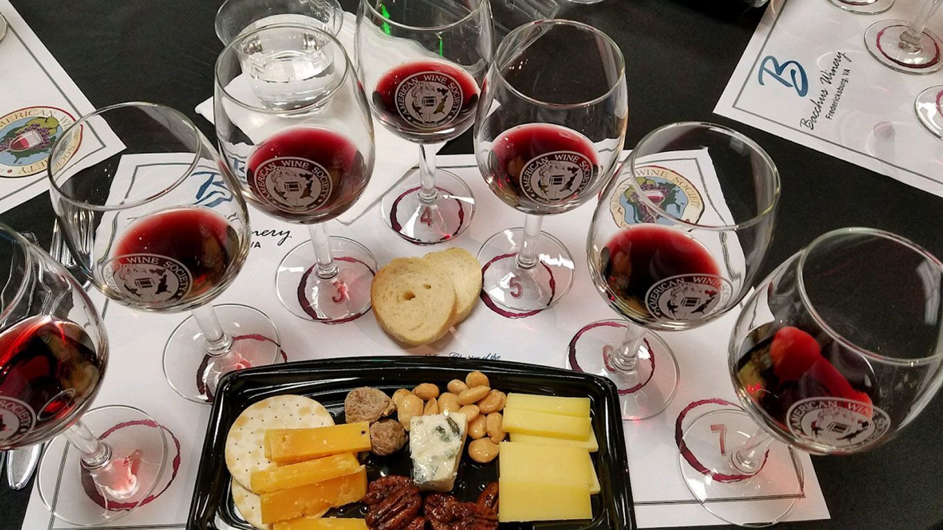 A table topped with a variety of food and wine glasses.