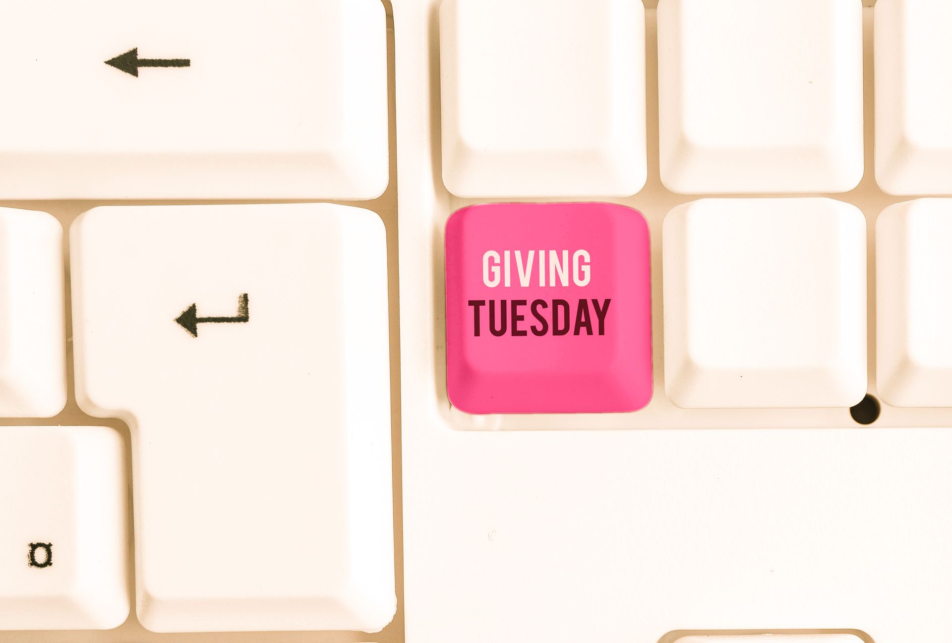 Keyboard with one pink key saying Giving Tuesday
