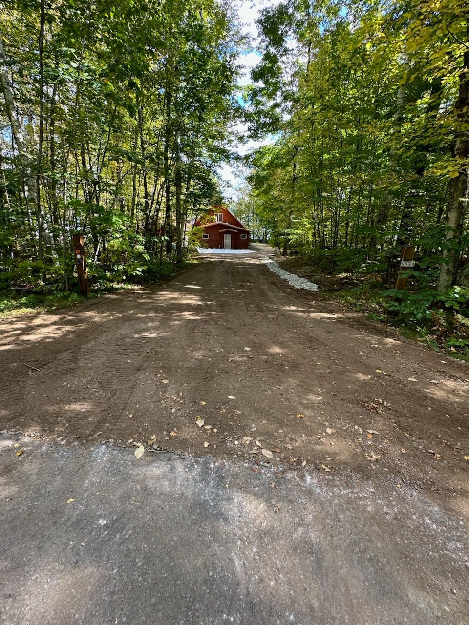 A group of men are working on a concrete driveway.