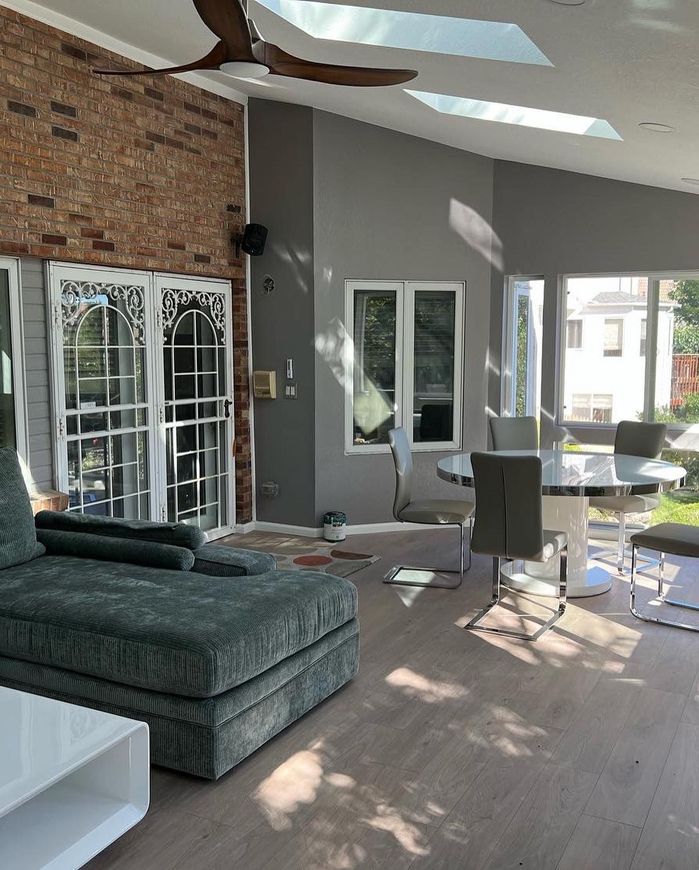 A living room with a couch and a table and chairs