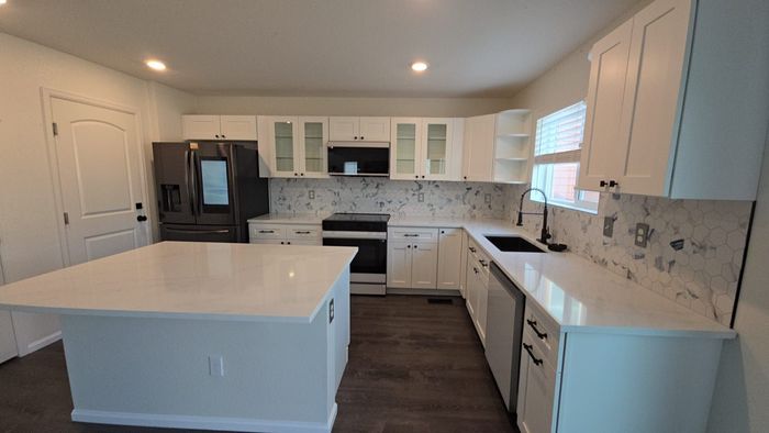 Kitchen cabinets with sink and island. 