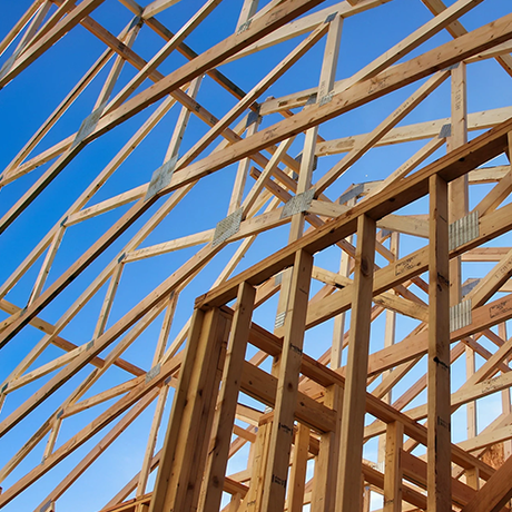 A building under construction with a blue sky in the background.