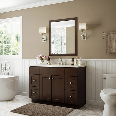 A bathroom with a sink , toilet , tub and mirror