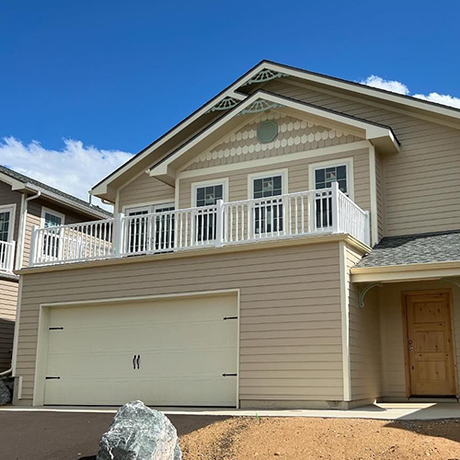 A large house with a large garage and a balcony.